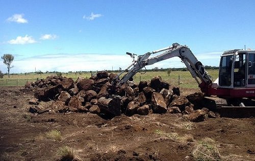 Excavator removing rocks